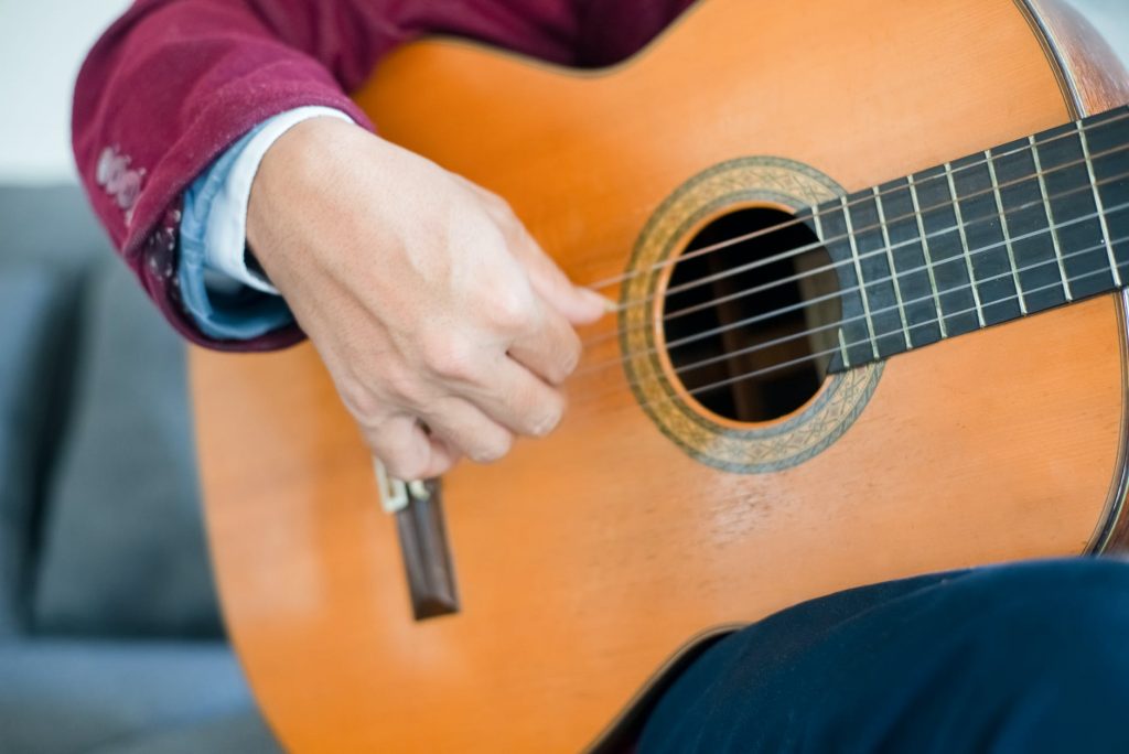 a person playing an acoustic guitar